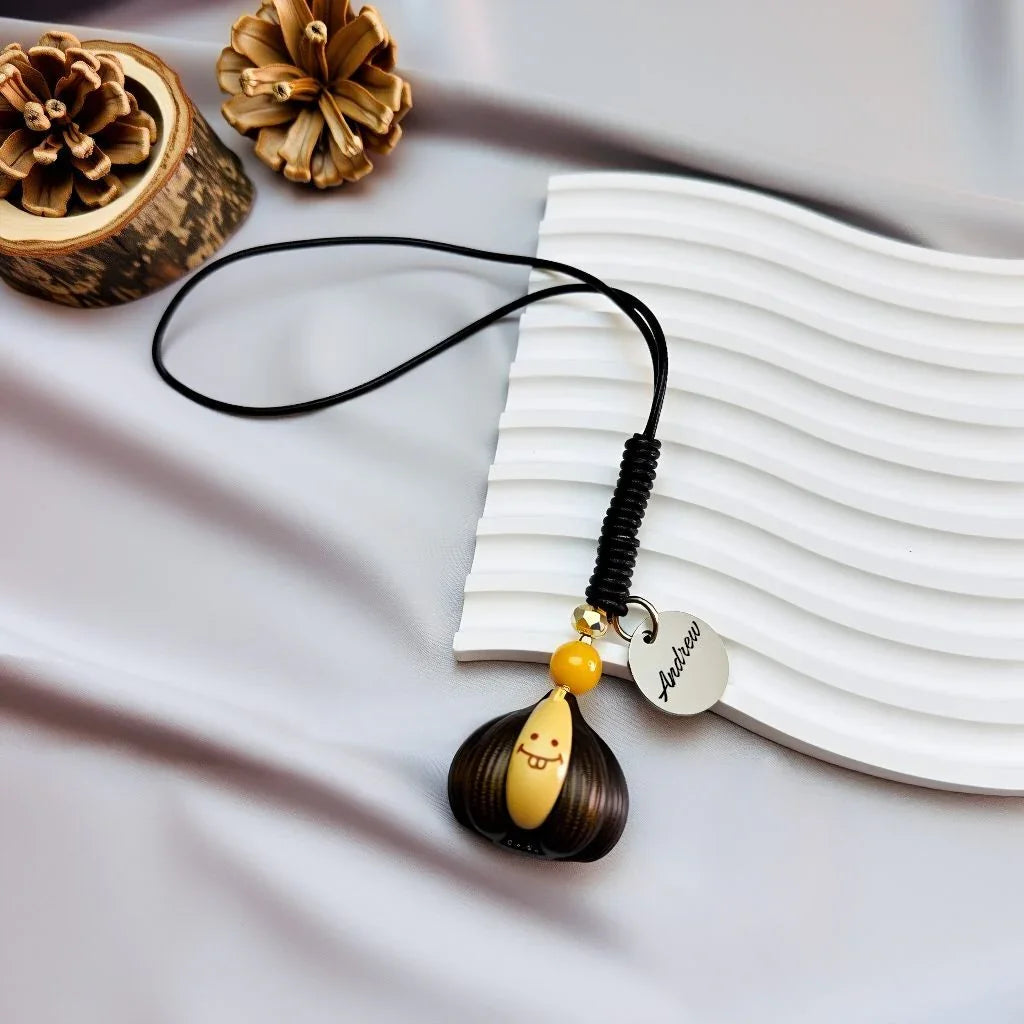 Premium Agarwood "Victory in Hand" bag charm with a custom engraved stainless steel name tag and Yellow Agate