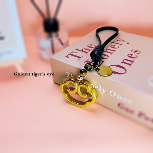 Brass cloud charm accented with golden tiger's eye beads, combining natural stones and handcrafted metal for a feng shui-inspired bag accessory