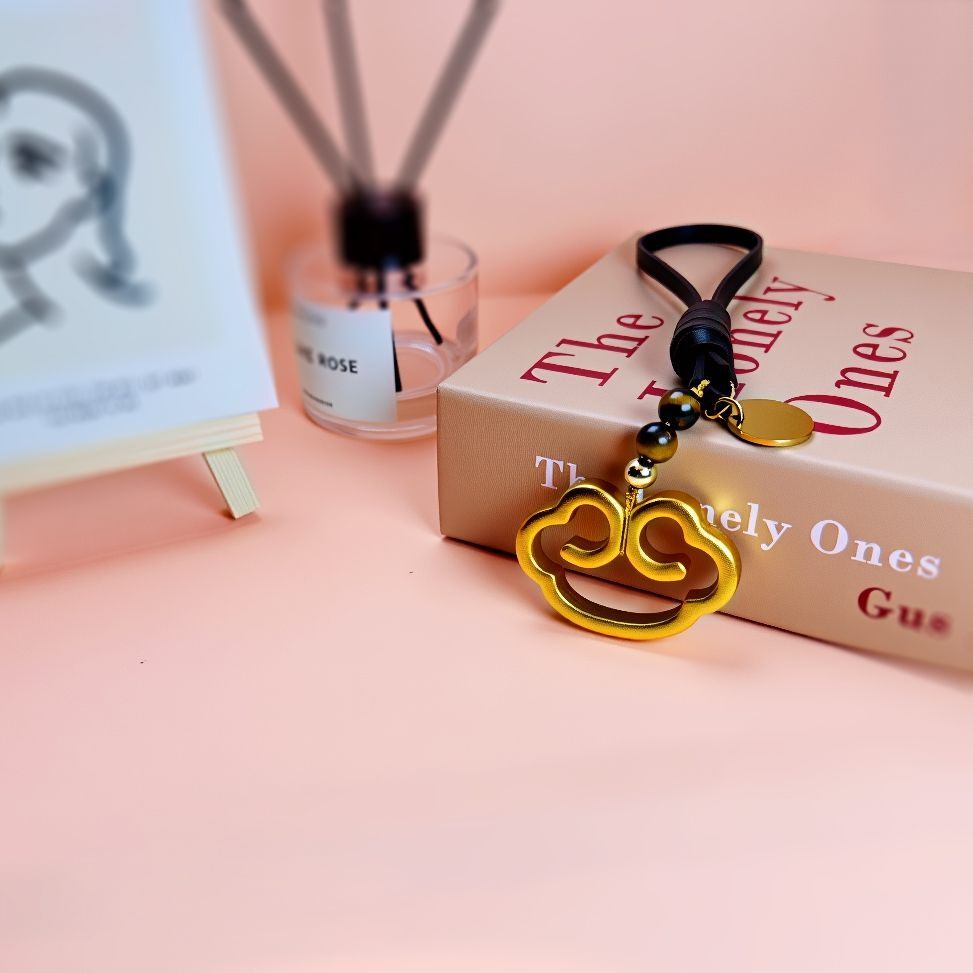 Elegant brass cloud-shaped bag charm with customizable name tag, featuring spiritual feng shui design, handmade with energy-infused materials