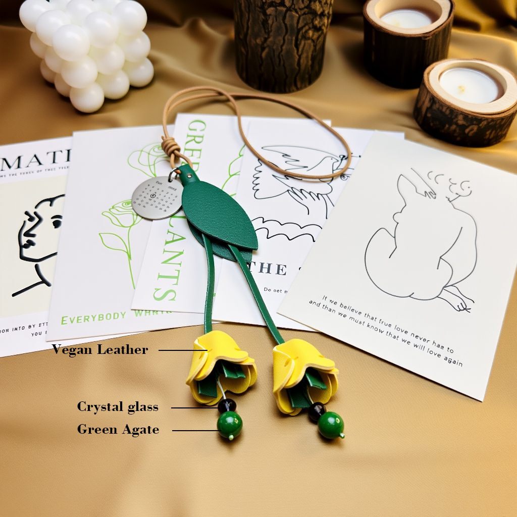 Close view of finished leather tulip charm highlighting vegan leather, crystal-glass accents, and green agate beads.