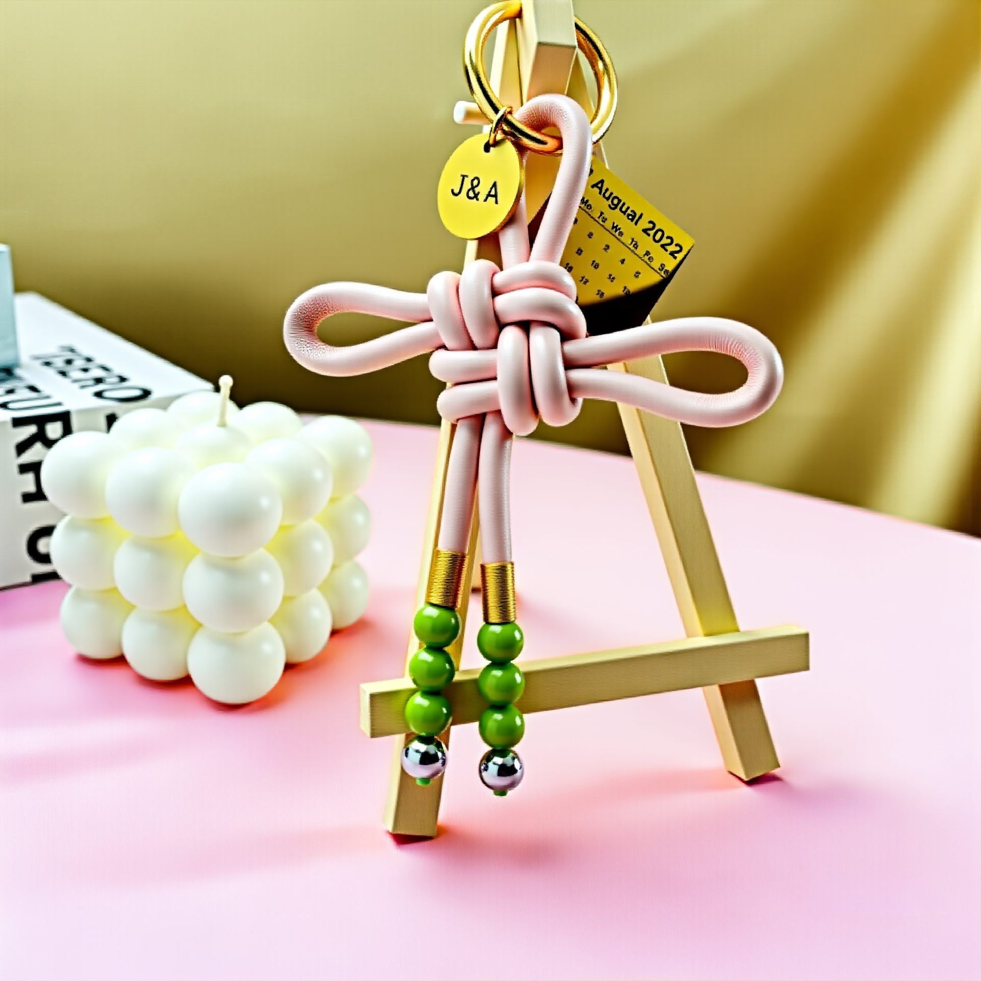 Handwoven leather love knot bag pendant with green art glass beads and fashion alloy beads, romantic couple keychain, personalized anniversary gift, love and connection collection, stylish handmade bag charm for men and women