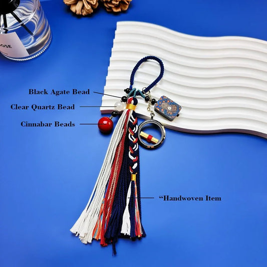 Close-up of Black Onyx, Cinnabar beads, and Clear Quartz on a sandalwood tassel charm