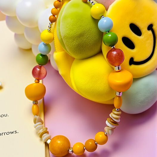 Beaded strap detail with rose quartz, yellow agate, natural white shell and colored glass on smiley sunflower plush bag charm (energy stone bag charm, bagcharms)