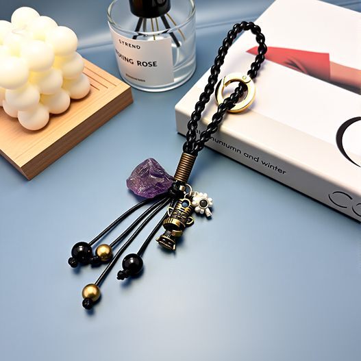 Full view of travel bronze totem bag charm—braided strap, amethyst, obsidian and copper bead tassels, gift-ready display (bagcharms)