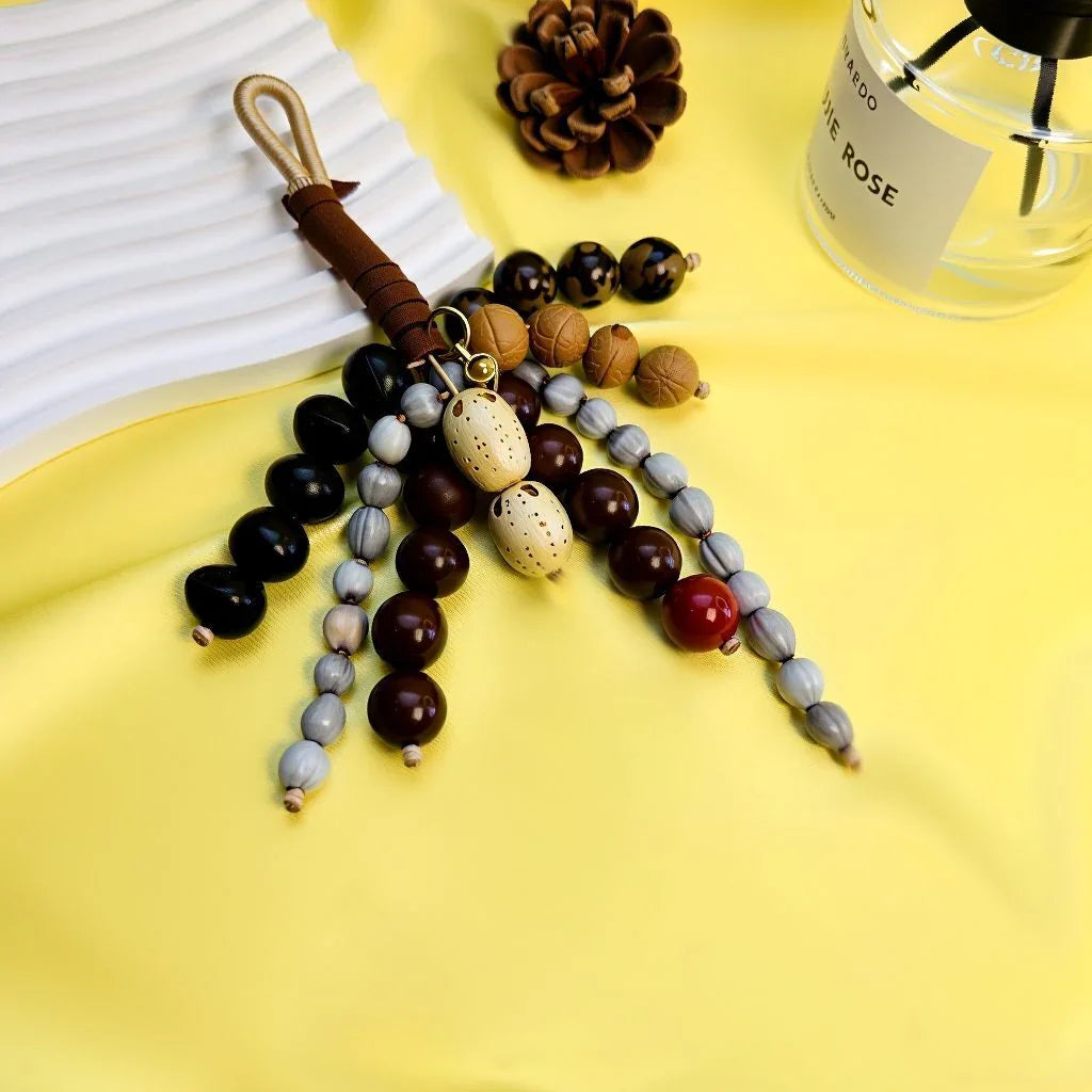 Handcrafted Wish-Fulfilling Seed Tassel Bag Charm featuring 7 sacred natural elements and custom photo projection