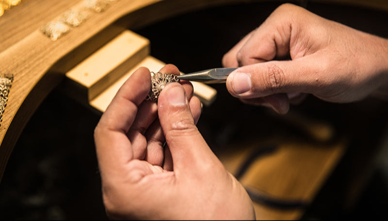 Bondora Fortuna artisanal process: A master jeweler meticulously hand-forging a high-quality spiritual charm.