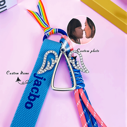 Angel edition kids backpack charm with embroidered custom name and optional photo charm—rainbow loop, rhinestone wings, and paracord tassels.