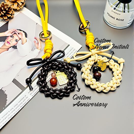 Handwoven couple wreath bag charm customization—add initials and anniversary date on gold disc; braided leather bows, two color options (bagcharms)