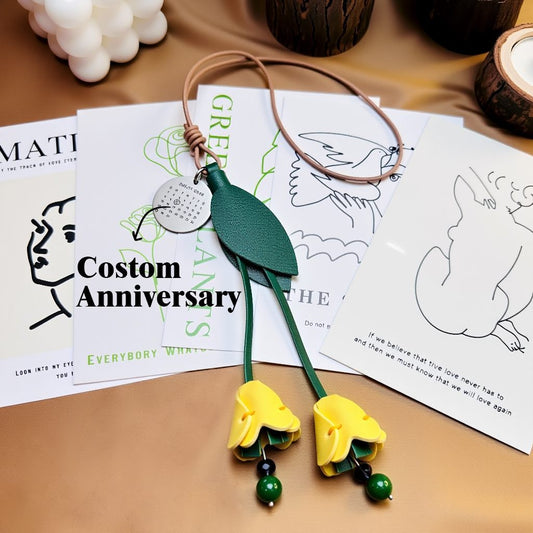 Leather tulip bag charm with custom engraved anniversary calendar disc.