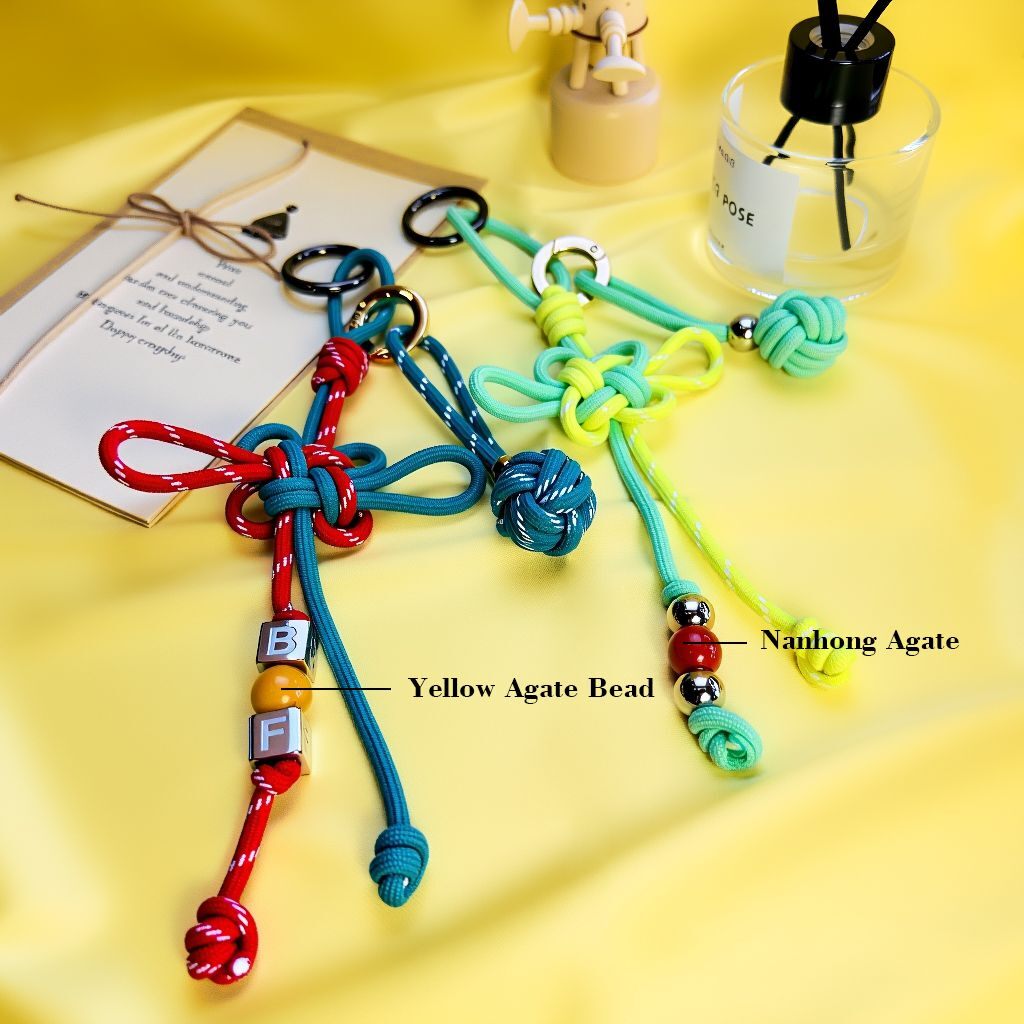 Lucky knot bag charm highlighting Yellow Agate bead and Nanhong red agate with metal beads — handmade bagcharms.