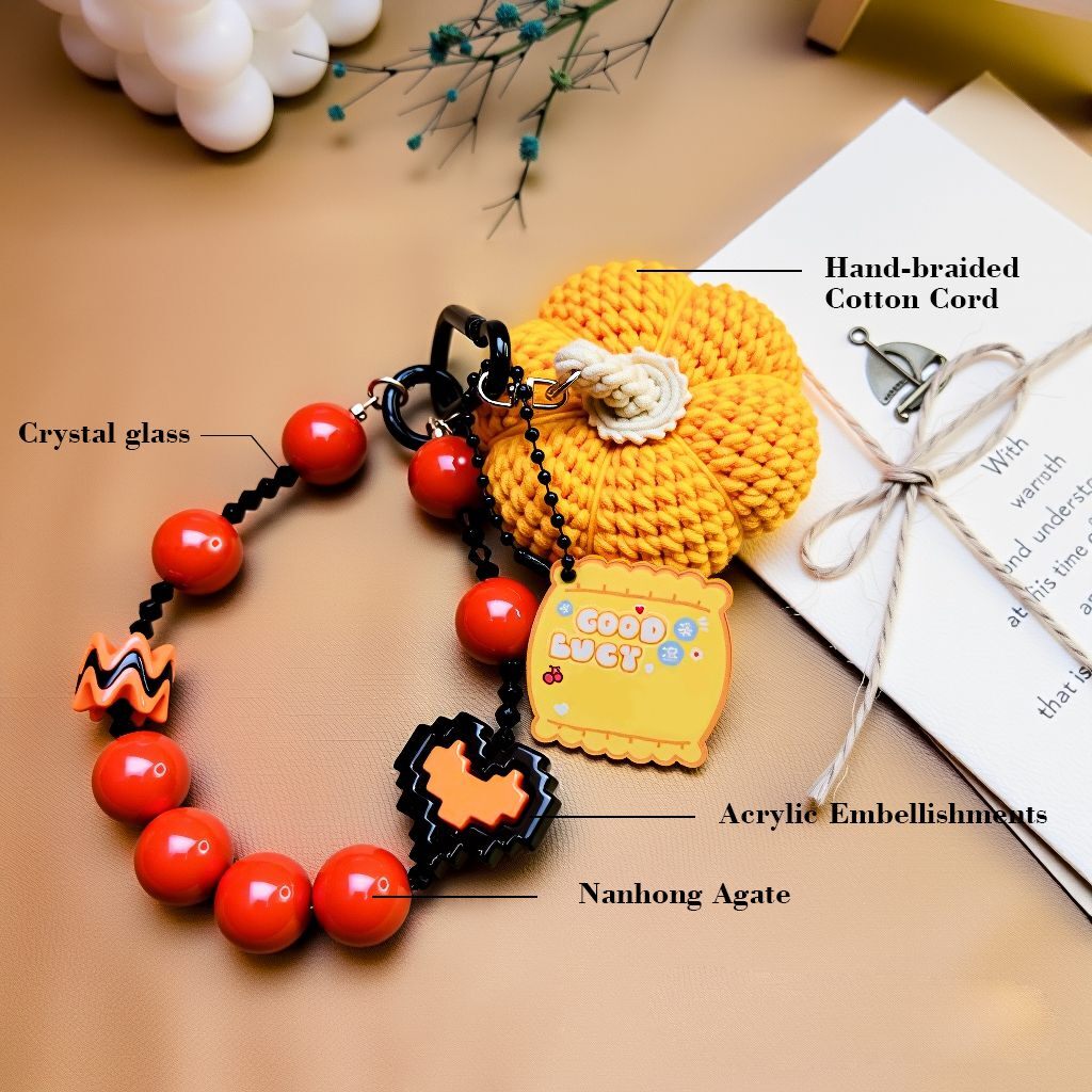 Hand-braided cotton pumpkin Halloween bag charm with Nanhong (South Red) agate beads, crystal glass and acrylic accents—materials callout (bagcharms)