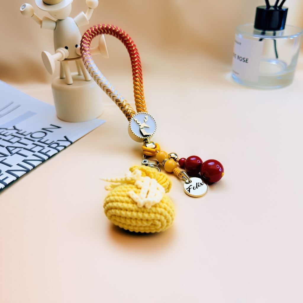 Handmade yellow crocheted money bag keychain with Nanhong agate and art glass beads, personalized name tag, lucky charm purse accessory for wealth and protection, unique bag charm gift