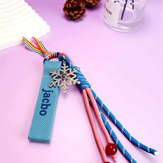 Personalized kids backpack name tag with bold green embroidery and a snowflake photo projection charm.